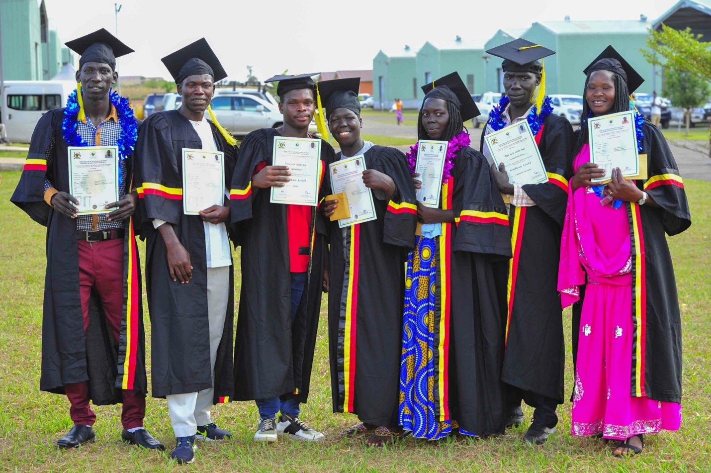 (Left – right) Ogwal Ceaser, Obuku Oscar Jaspher, Ogwal Daniel, Angweeh Racheal Unity, Akullu Sharon, Ayane Okello Moses and Apili Winny display their certificates as the best students during the 1st graduation of the Presidential Initiative for Zonal Industrial Parks for Skills Development, Value Addition and Wealth creation at the Lango Zonal Industrial Hub in Gulu district on 3rd January 2023 