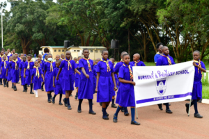 Girl Guides matching to brass band at Kololo ceremonial grounds to mark 100 years of Uganda Girl Guides Association on Friday 15th  April 2023