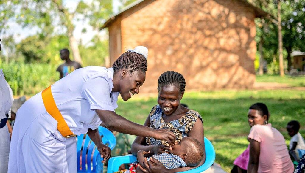 One of Village Health Teams (VHTs) nurse immunising a child