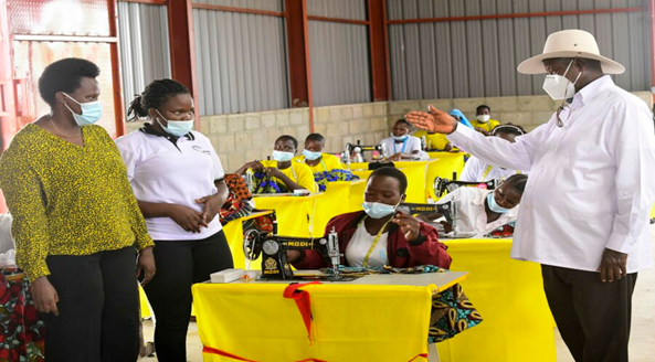 President Museveni checking out the tailoring skills of the youths as he commissions Adjumani Zonal Industrial Hub